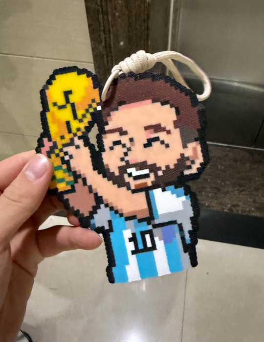 Lionel Messi Pixel Charm – Q‑Style with World Cup Trophy & #10 Argentina Kit – Celebratory Champion