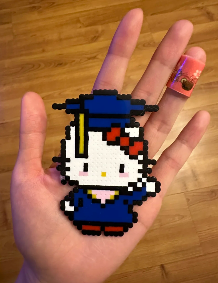 Hello Kitty Graduation Pixel Charm – Matte Texture & Black Outline – Commemorative Cap & Gown Decor