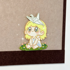 Girl with Paper Crane – Sitting on Flower Meadow – Soft Pastel Perler Art