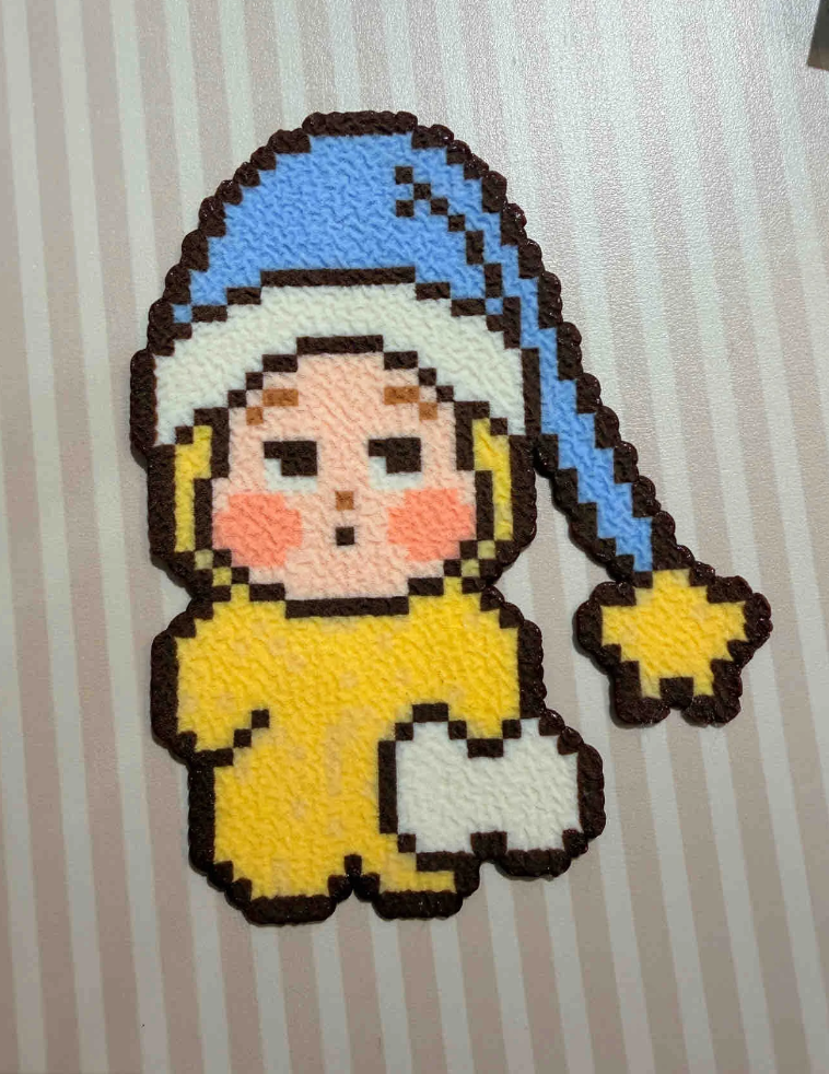 Sleepy Baby Pixel Charm – Blue Nightcap, Star Accent & Yellow Onesie – Cozy Cartoon Decor