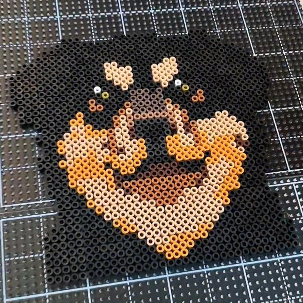 May include: A pixel art depiction of a Rottweiler dog's face, crafted from small black, tan, and brown beads. The dog's features are well-defined, with emphasis on the eyes and snout. The artwork is set against a grid background.